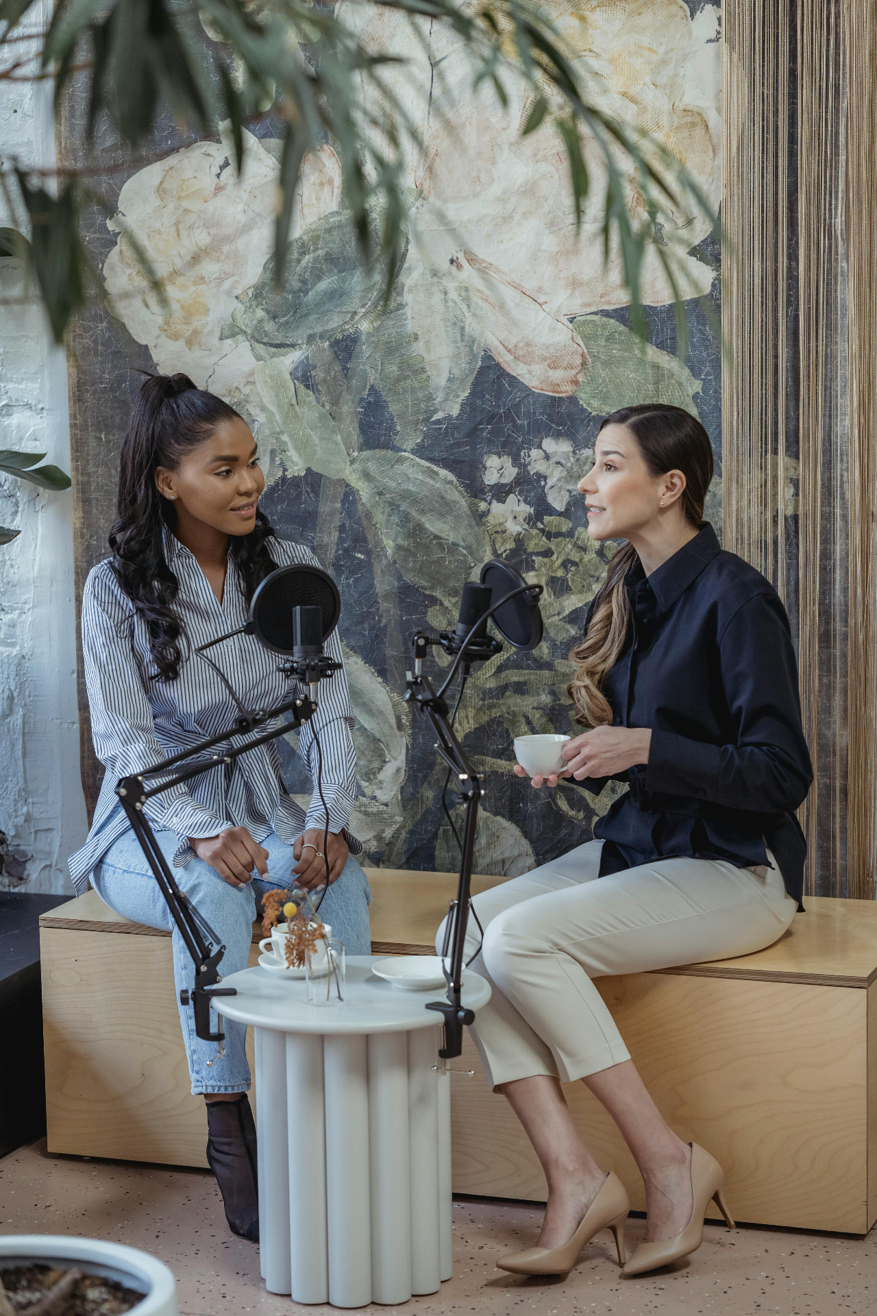 Two women in conversation in a design-led podcast studio